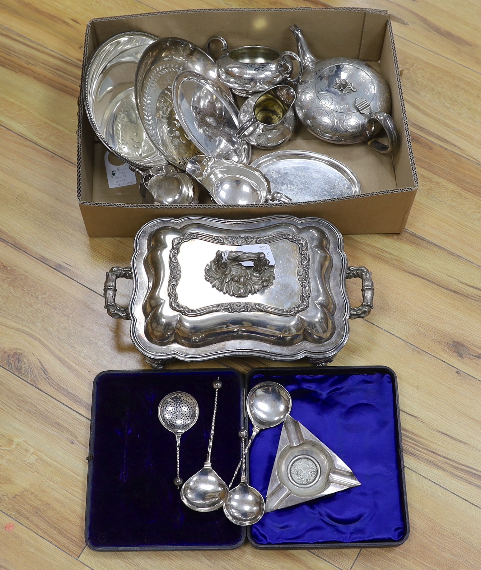 A collection of plated wares: an oval card tray, tureen and cover, cased four piece spoon desert set and an inset coin ashtray etc